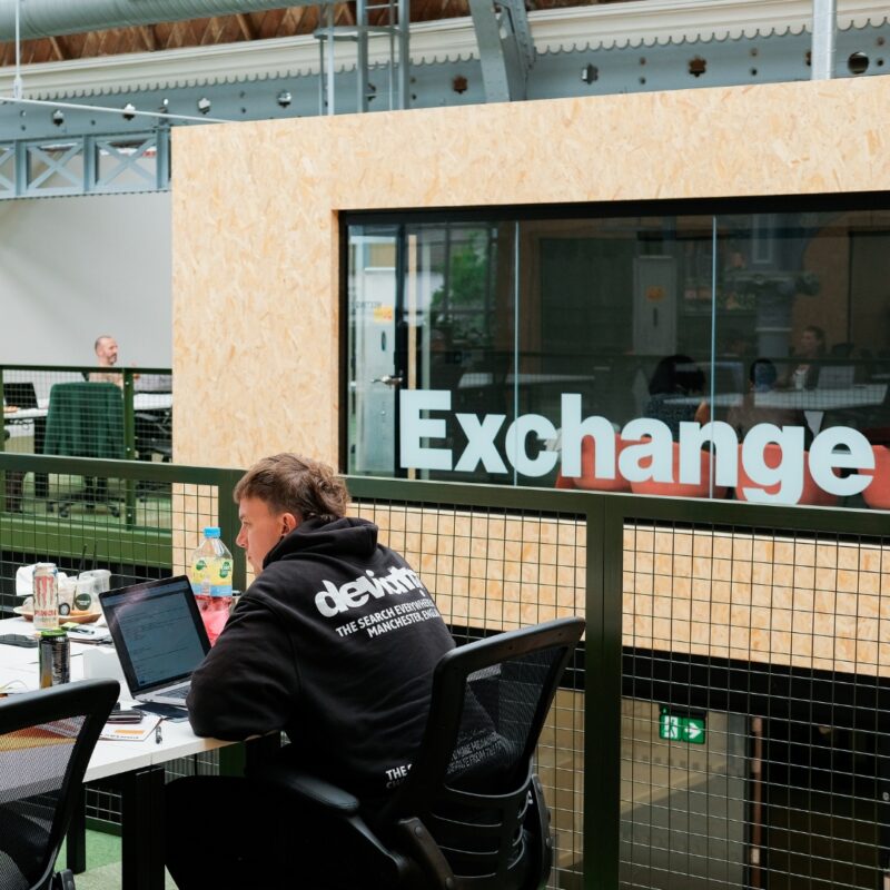 person working at campfield with exchange logo behind