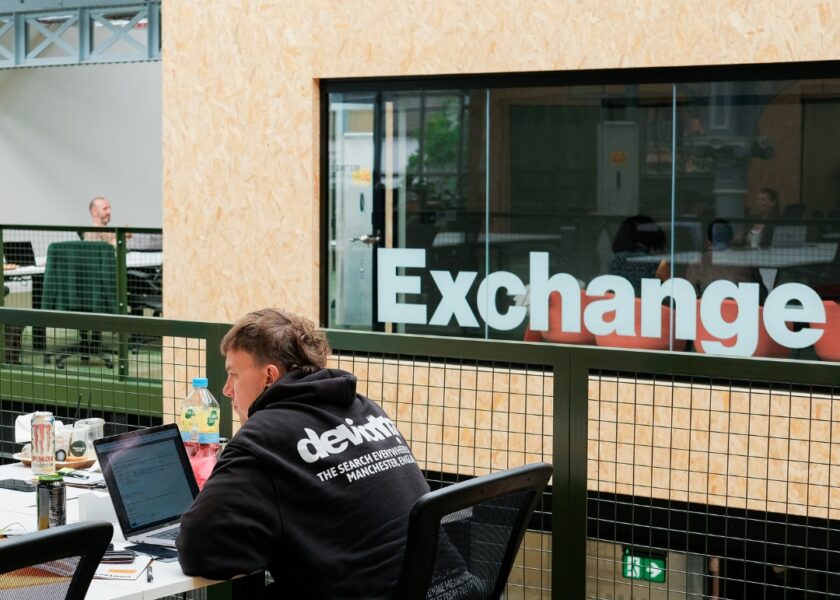 person working at campfield with exchange logo behind