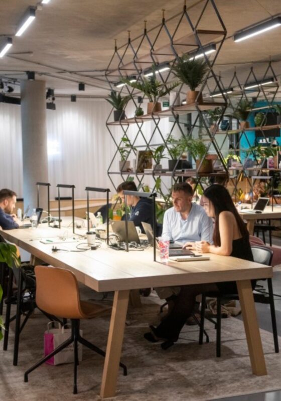 people working at a desk in a manchester office space